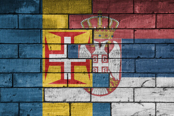 colourful painted big national flag of madeira and flag of serbia on a massive old brick wall background. concept