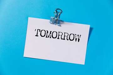 he word tomorrow on torn paper