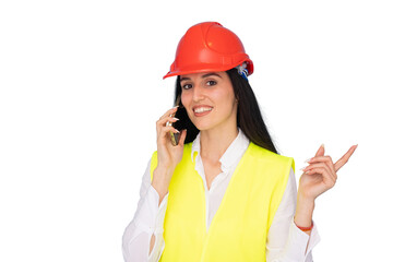 Young architect wearing safety helmet and vest is speaking on phone and pointing with finger on transparent background