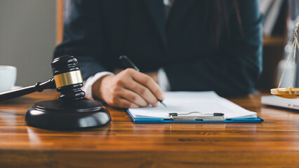 Justice and lawfirm concept. Female lawyer in office with brass scale. Woman hand gavel to bang. Law and justice trial session. Business lawyer notary stamping agreement, company secretary, validity.