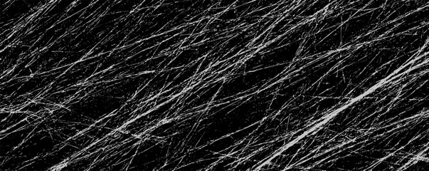 Abstract black and white texture with streaks resembling scratched surfaces in an artistic layout