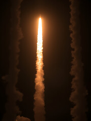 Rocket launch smoke effects with bright flame trails - dynamic white exhaust plumes, upward illuminated thrust streams, burning fire particle. Spacecraft takeoff and space exploration visual elements.