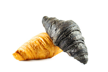 Classic and black croissants isolated on white background.