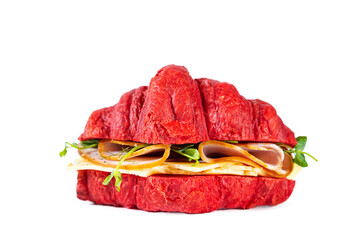 Red croissant sandwich with cheese, ham and pea microgreens isolated on white.