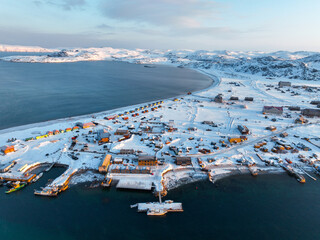 Elevated view of the snow-covered village of Teriberka bordering the Barents Sea in Murmansk Oblast, Russia