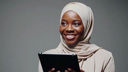 Smiling woman using tablet in a modern studio setting - Powered by Adobe