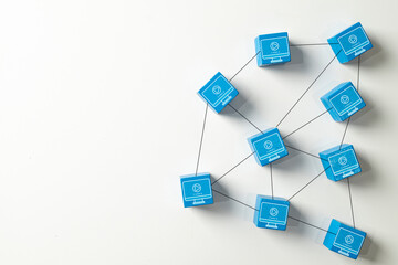 Blue wooden blocks with video icons connected in a network.Concept for e-learning,online learning platforms,video streaming,social media content,distance education,and modern school technology.