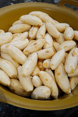 lots of bananas. banana without skin. bananas on the tray