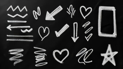 A collection of chalk outlines depicting arrows, hearts, lines, and a smartphone on a blackboard. The doodles create an artistic and playful atmosphere, suitable for educational purposes