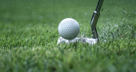 Golf club hits a golf ball.