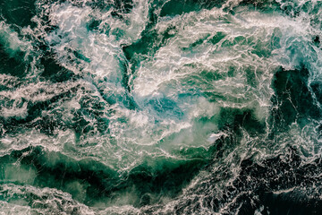 Blue waves of water of the river and the sea meet each other during high tide and low tide.