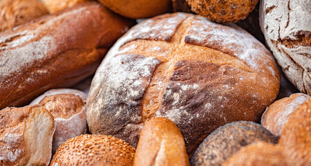 Freshly baked natural bread is on the kitchen table.