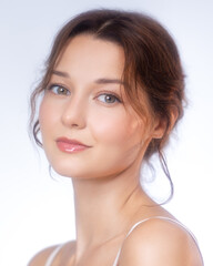 Fototapeta premium Elegant Female Model With Radiant Skin In Clean White Studio Light