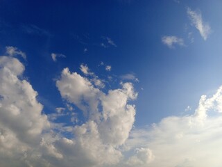 Expansive Blue Sky with Fluffy Cumulus Clouds