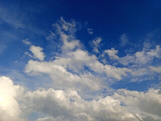 Expansive Blue Sky with Fluffy Cumulus Clouds