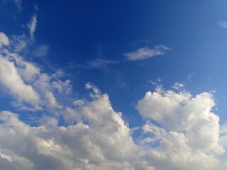 Expansive Blue Sky with Fluffy Cumulus Clouds
