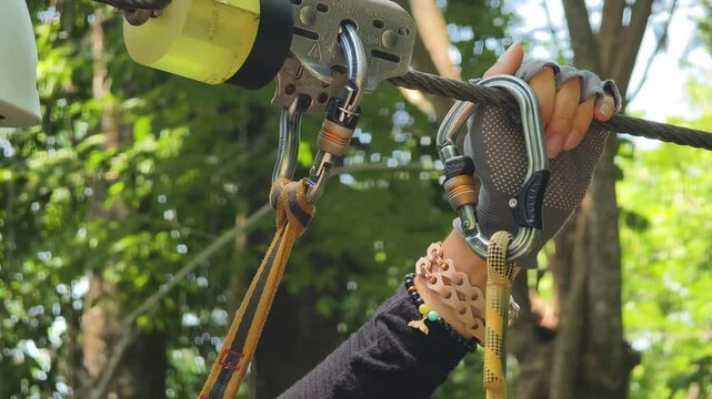 A woman is walking across a challenging ropes course in the extreme park