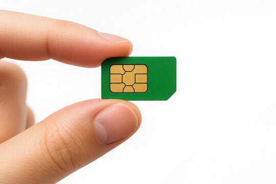 Close up of a hand holding a green sim card isolated against a white background for technological concepts