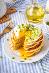 Tasty savory breakfast pancakes with spring green onion and fried eggs