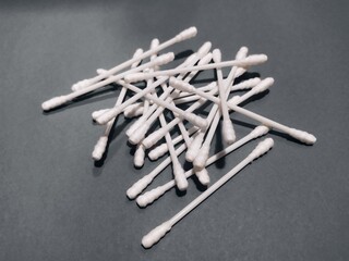 some cotton buds on black background