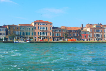 colorful houses with beautiful sunshine and clearly blue sky on the island of Venice, Italy