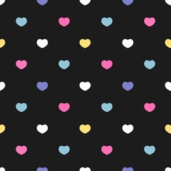 Seamless colorful heart pattern on black background. Fun and cute repeat design, ideal for Valentine's Day, kids fabric, wrapping paper, and romantic-themed projects.