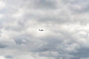 Airplane flying through overcast sky