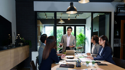 Business Meeting Presentation Asian Businessman Leading Discussion with Team in Modern Office Collaboration and Strategy in Conference Room