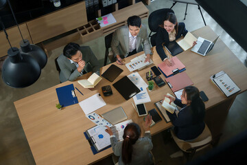 Asian Business Team Collaboration Meeting in Office Analyzing Financial Data Charts Graphs Reports for Strategy Success and Corporate Growth Top View