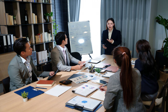 Asian Business Team Meeting Real Estate Strategy in Office Collaboration Presentation Discussing Financials Data and Investment Planning