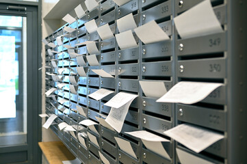 Rows of mailboxes with many paper utility bills