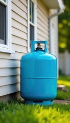 A propane tank sits beside a house, ready to supply natural gas for home heating and cooking The bright blue tank contrasts with the green grass and neutral-colored siding , blue tank, outdoor tank