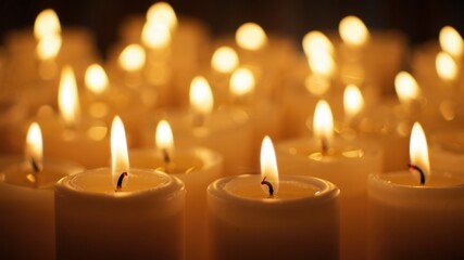 Row of burning candles in dim light, memorial tribute, remembrance ceremony, solemn atmosphere, spiritual reflection, peaceful vigil