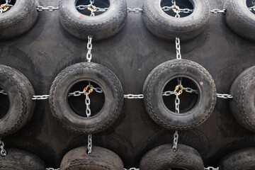 Large marine fender with tires and chains.