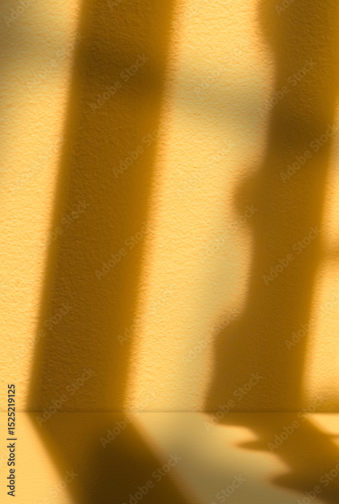 Poster light and shadow on orange background.studio background with window light on yellow podium with natu