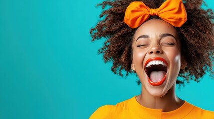 A joyful portrait of a woman with a bright orange bow in her curly hair, laughing loudly against a vibrant turquoise background, radiating positivity and happiness.