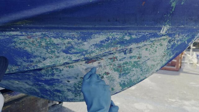 Antifouling scrap tool removing old paint boat hull to leave gelcoat clean