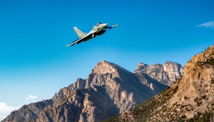 fighter jet soars high above rugged mountain landscape during a clear afternoon