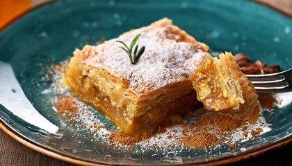 close up of a fork picking a piece of delicious chicken pastilla a traditional moroccan dish sprinkled with powdered sugar and cinnamon