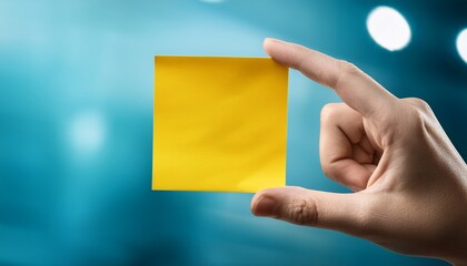 hand holding yellow sticky note