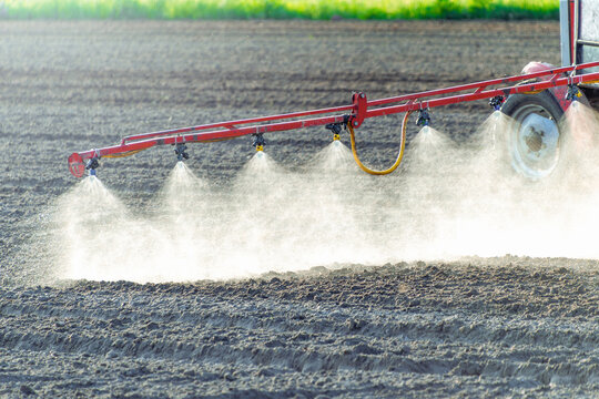 Agricultural irrigation system spraying water on field with water sprinklers