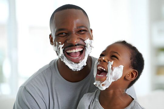 A joyful father and son share a laugh, faces covered in shaving cream