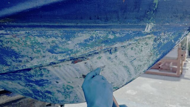 Antifouling scrap tool removing old paint boat hull to leave gelcoat clean