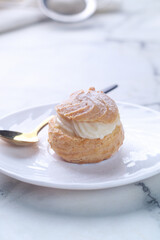 Kue Sus Isi Vla or soes cake (Choux Pastry Cream Puff) is Crispy and airy choux pastry shell are filled with smooth and soft custard cream. 