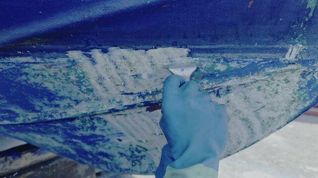 Antifouling scrap tool removing old paint boat hull to leave gelcoat clean