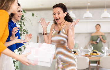 Happy women greeting each other before starting a house party