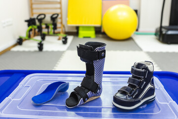 Supportive footwear and mobility aids are organized for children's physical rehabilitation activities in physical therapy clinic