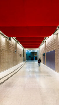 MAY 15, 2025, PARIS, FRANCE: Empty Paris metro hallway features concrete walls and red ceiling. Image is suitable for architecture, design, or urban environment concepts.