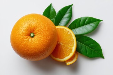 An orange fruit with cut slices  green leaves on a white surface shot from above
