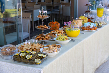 Outdoor catering buffet with a variety of food snacks and appetizers
